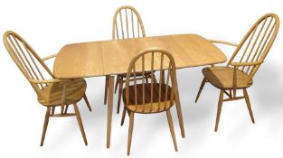 A wooden dining table most likely Ercol, along with