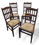 A set of four 20th century stained oak dining chairs