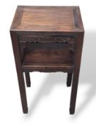 An oriental hardwood table with block legs