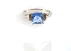 A white gold blue single stone ring, marked ‘375’,