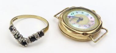 A 9ct gold V shaped ring set with dark blue and wh