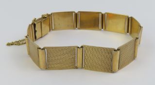 A 9ct gold panel shaped bracelet, with a safety ch