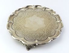 A Victorian silver salver with rim divided by curv