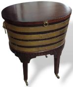 A mahogany stained wine cooler with brass bindings