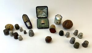 A collection of thimble cases and thimbles to incl