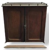 A late 19th or 20th century oak table top cabinet,