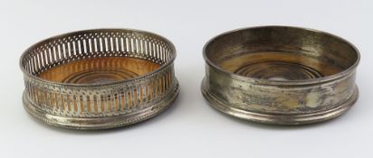 Two silver wine coasters of different designs. One