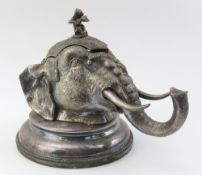 A decorative ink well of silver plate, in the form
