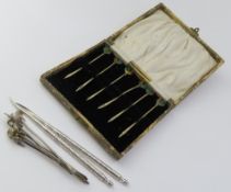 A set of six silver picks set with enamelled cocke
