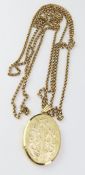 A 9ct gold oval hinged locket with engraved floral