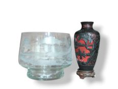 A metal and enamel vase with applied textured red