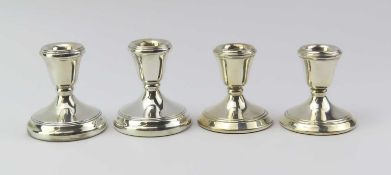 A pair of silver dwarf candlestick holders