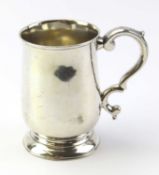 A silver christening mug with smooth body