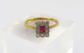 A ruby and diamond cluster ring, marked ‘18ct plat’
