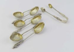 A set of six silver apostle teaspoons along with a pair of tongs