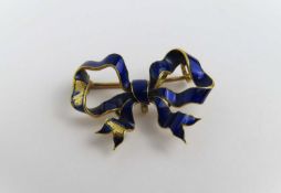 A blue enamel bow shaped brooch