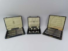 Three cased sets of silver items