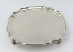 A silver salver with smooth graduated rim