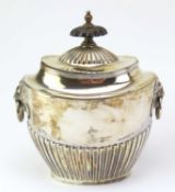A silver tea caddy of oval form