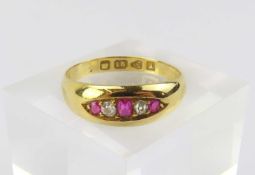 An 18ct gold gypsy style ruby and diamond five stone ring