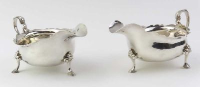 A pair of Britannia standard silver cream jugs