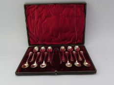 A cased set of twelve silver teaspoons and one set of tongs
