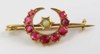 A ruby and pearl set crescent brooch