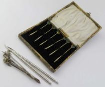 A set of six silver picks set with enamelled cockerel decoration