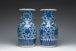 Two Chinese blue and white 'lotus scroll' vases with relief design, 19th C.