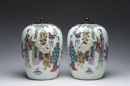 A pair of Chinese qianjiang cai jars and covers with ladies and children in a palace garden, 19th/20