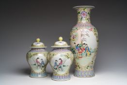 A Chinese famille rose yellow-ground baluster vase and a pair of vases and covers with animated scen