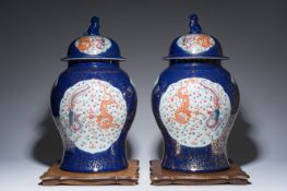 A pair of large Chinese famille rose blue-ground 'dragons and phoenixes' vases and covers, Kangxi ma