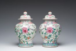 A pair of Chinese famille rose vases and covers with birds among blossoming branches, 19th C.