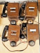 Four early 20th century railways signal box telephones, all with black bakelite handles and wooden