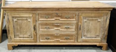 19th century pale oak sideboard comprising a central bank of three drawers with moulded edges and