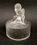 Lalique 'Amour Assis' cylindrical frosted glass cover, surmounted with a kneeling putto, the side