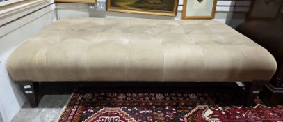John Sankey ottoman stool having a buttoned suede leather pale tan upholstered seat, on square