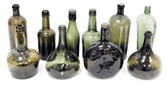 A collection of early 20th century green tinted wine bottles and others similar, including