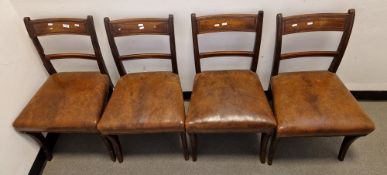 Set of four Regency mahogany dining chairs with channelled top rail, stuffover seat, on sabre