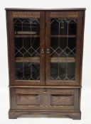 Mid-20th century dark oak display cabinet in the 17th century manner, the two leaded glazed doors