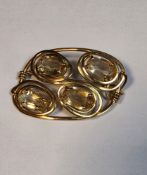 14ct yellow gold (stamped 585) brooch of contemporary form claw set with four oval faceted citrines,