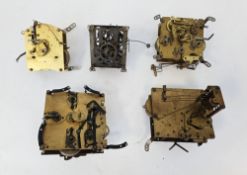 Five early 20th century brass clock movements including Smiths Enfield and G.H.S, largest 14cm