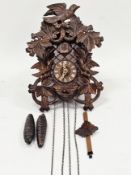 Black Forest cuckoo clock, 20th century, the case decorated with carved birds and foliage and marked