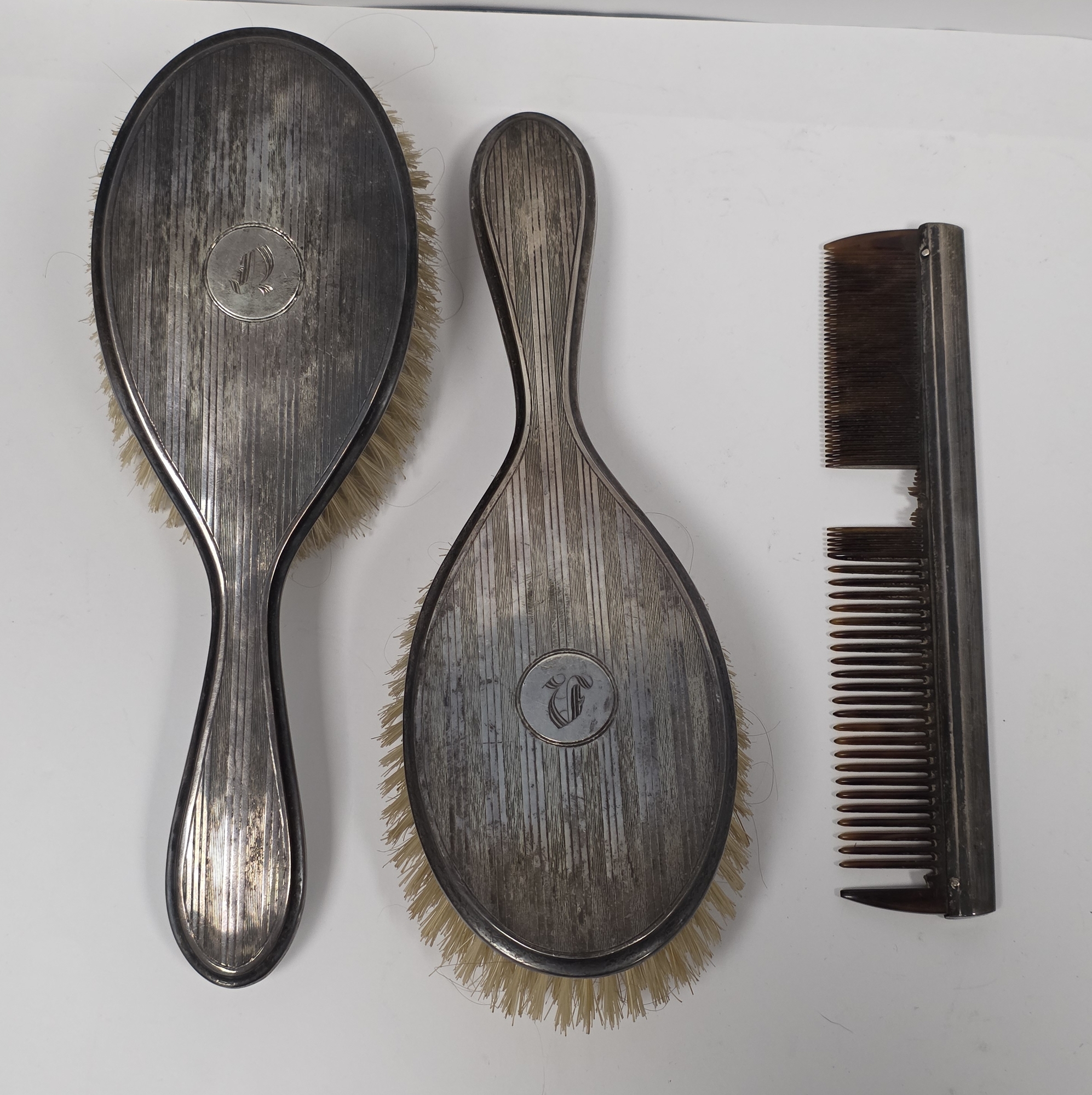 George V silver backed three-piece dressing table set, Sheffield 1925 and 1926, Walker & Hall,