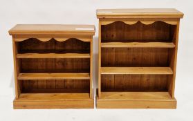 Two similar pine bookcases, each with rectangular tops and wavy shaped friezes, two fixed shelves,