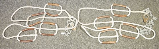 Two climbing ropes, each with four pairs of leather covered integrated handles, on galvanised