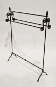 Black wrought iron hand forged towel rail with scrolling brackets, 102cm high x 79cm wide x 23cm