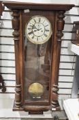 Victorian Vienna regulator wall clock, walnut cased, the white enamel dial with two winding holes,