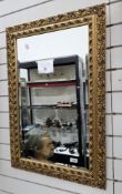 Gilt-framed rectangular mirror in the 18th century style, the frame with foliate scroll pierced