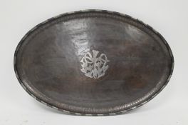 Hugh Wallis (1871-1943) Arts and Crafts oval planished copper tray, the centre pewter inlaid with